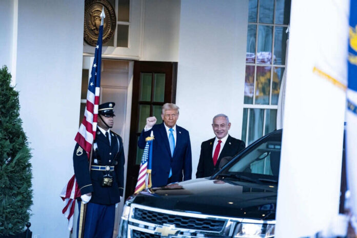 Two men in suits near soldier and car
