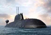 A large submarine emerging from the water against a cloudy sky