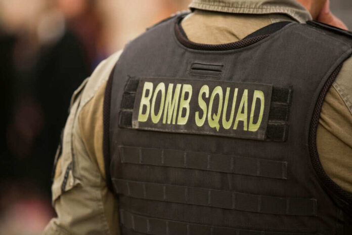Person wearing bomb squad vest at event