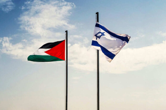 Palestinian and Israeli flags on flagpoles against sky
