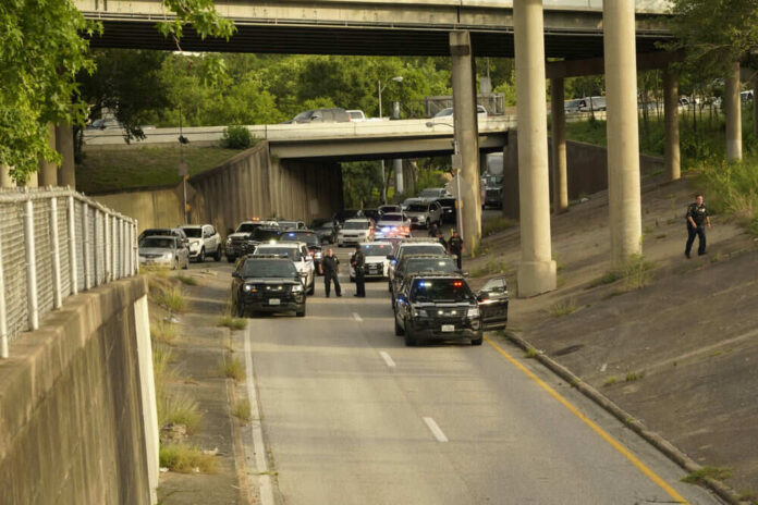 1744460810 Police cars blocking road underneath highway overpass