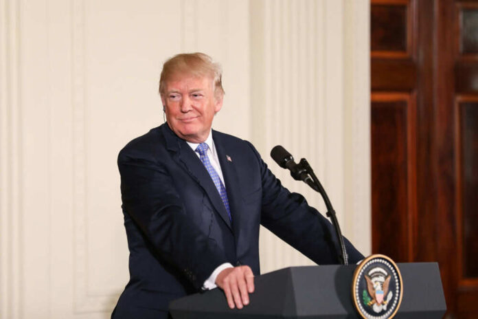 Person standing at podium with presidential seal