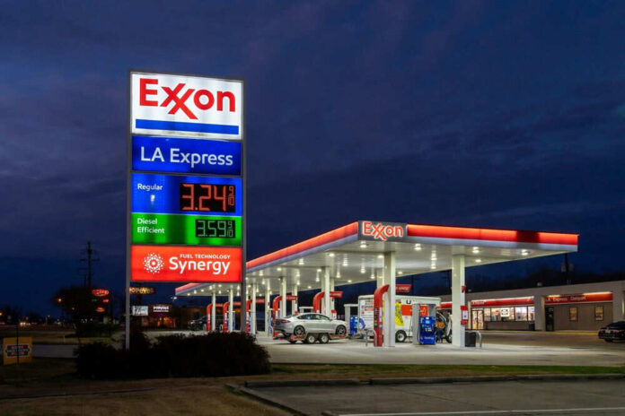 Exxon gas station with fuel price sign illuminated