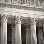 Stone columns with equal justice under law inscription