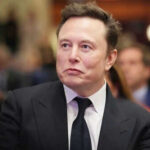 Man in suit at an event looking sideways