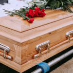 93-Year-Old EXECUTES Wife In Parking Lot Wooden coffin with red roses and green leaves